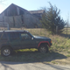 The XJ stands in front of an abandoned barn in MIssouri.